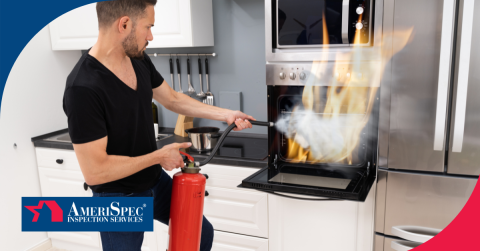 Man using a fire extinguisher to put out an oven fire in a kitchen