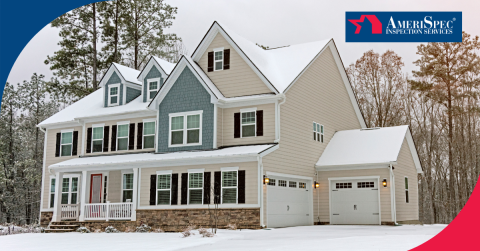 Two-story home with snow-covered roof and yard surrounded by trees.