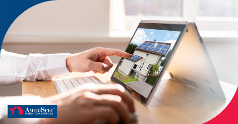 Person using a touchscreen laptop to view a home with solar panels.