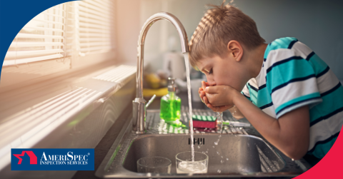 Child drinking water from a kitchen faucet.