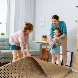 The mother and her kids turning living room chores into a fun activity